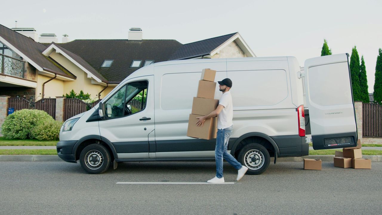 white van with doors open delivering parcels