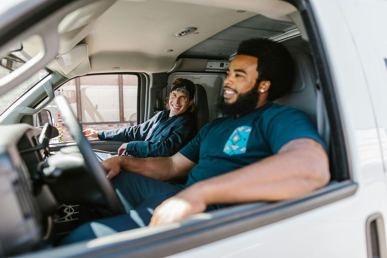two men in van smiling