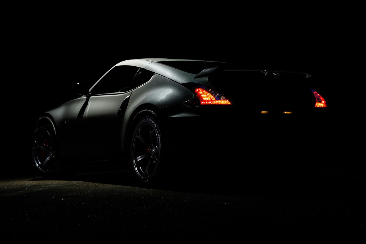 sports car in the dark with rear lights on
